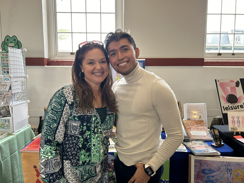Educator and colleague at community book fair