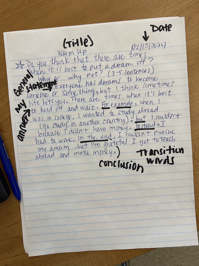 Annotated warm-up paragraph with transition words